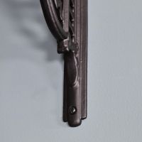 Close-up of the Fixing Holes on the Black Shelf Bracket