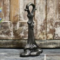 Natural iron door stop by rustic door