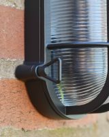 Close up of aluminium cage detailing on exterior wall lantern