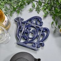 Blue Cast Iron Kettle Trivet on Blue Table