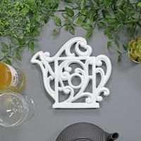 Cream Cast Iron Kettle Trivet on Table