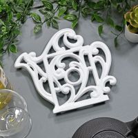 Cream Cast Iron Kettle Trivet on Blue Table