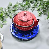 Blue Round Cast Iron Trivet in Use with Teapot