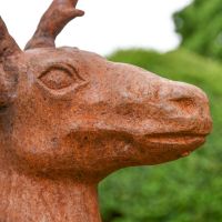Close up of head and facial expressions on cast iron stag sculpture