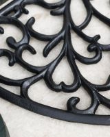 Close-Up of Delicate Twisted Pattern on Cast Iron Door Mat Close-Up of Delicate Twisted Pattern on Cast Iron Door Mat
