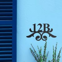 Traditional Iron Ornate Number Sign on a Blue Wall Traditional Iron Ornate Number Sign on a Blue Wall