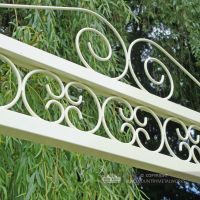 Ornate scroll work on top of swing seat