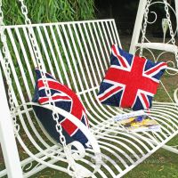 Ornate scrolled arm rest on cream garden hammock