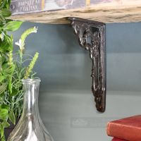 Cast Iron Ornate Shelf Bracket Holding Up a Wooden Shelf Cast Iron Ornate Shelf Bracket Holding Up a Wooden Shelf