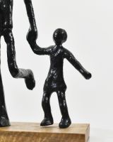 close up of child on mango wood and aluminium art sculpture