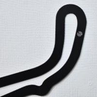 Close up of pre-drilled hole within race track for wall mounting 