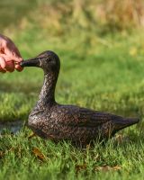 Pair of Cast Aluminium Ducks Sitting Version in a Bronze Finish with Hand in Shot for Scale