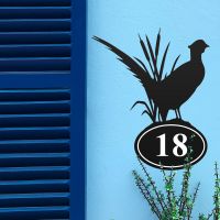 Pheasant Iron House Number Sign in Situ on a Blue Wall 