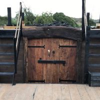 Polished Brass Pirate door knocker on wooden doors