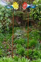 Vintage Airplane Wind Spinner Stakes in Blue and Yellow next to Red Version