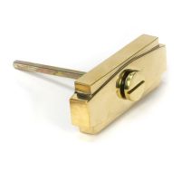 Close-Up of Lone Polished Brass Art Deco Bathroom Thumb Lock Close-Up of Lone Polished Brass Art Deco Bathroom Thumb Lock