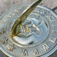 Close-Up of Polished Brass Sundial with Cast Shadow