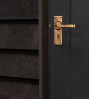Polished Copper Lever Lock Door Handle on Door