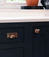 Polished Copper Rectangular Drawer Pull with Curved Hammered Handle in Situ