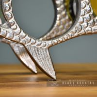 Detail on the Polished Nickel "Fish" Wine Rack Detail on the Polished Nickel "Fish" Wine Rack