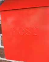 Close Up Of The Post Motif On The Modern Red Post Box