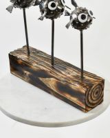 Close up of Pufferfish Family Sculpture wooden base