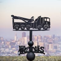 Recovery Truck Weathervane in Use by a City Skyline