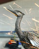 Close up of head and beak detail on recycled metal bird sculpture
