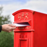 Close-Up of Letter Opening in Use on Freestanding Post Box Close-Up of Letter Opening in Use on Freestanding Post Box
