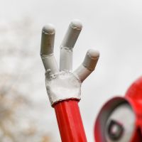 Close-up of Hand on Red Recycled Metal "Sweet Tooth" Henchman Sculpture Close-up of Hand on Red Recycled Metal "Sweet Tooth" Henchman Sculpture