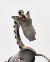 Close up of face and neck detail on scrap metal art sculpture Close up of face and neck detail on scrap metal art sculpture