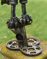 Close up of intricate feet detail on recycled metal art sculpture