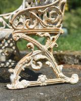 Close up of intricate side detailing on cast iron garden bench
