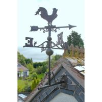 Rstic rooster weathervane on roof Rstic rooster weathervane on roof