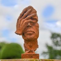 Rustic Cast Iron Abstract Face Sculpture in the Garden