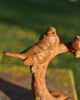 Close-Up of Rustic Cast Iron Three Little Birds Garden Sculpture