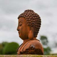 Side View of the Rustic Cast Iron Buddha Sculpture Side View of the Rustic Cast Iron Buddha Sculpture