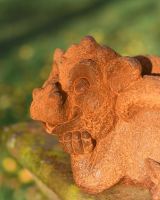 Close-Up of Facial Detail on Rustic Cast Iron Daydreaming Dragon Garden Sculpture