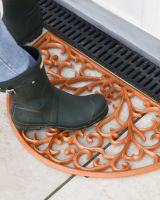 Scale Shot of Rustic Cast Iron Ornate "Sunrise" Semi Circle Door Mat