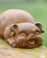 Close-Up of Rustic Cast Iron Rounded Lying Pig Garden Sculpture Close-Up of Rustic Cast Iron Rounded Lying Pig Garden Sculpture