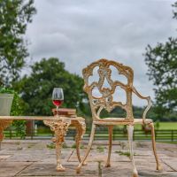 Rustic Cream Cast Iron Victorian Chair in Situ in the Garden Rustic Cream Cast Iron Victorian Chair in Situ in the Garden