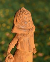 Close up of Rustic Cast Iron Girl With Basket  Close up of Rustic Cast Iron Girl With Basket