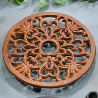 Heavy Duty Cast Iron Round Trivet Being Used on a Dining Room Table