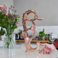 Copper "Seahorse" Wine Rack with hand for scale 