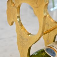 Close up of Gold "Seahorse" Wine Rack 