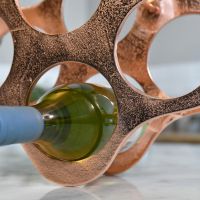 Close up of Copper finish on "Cloud" Wine Rack with Bottle 