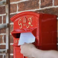 Close up of Letter being posted  Close up of Letter being posted