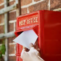 Letter Being Deposited into Red & Gold "Newland" Elizabeth Regina Post Box Letter Being Deposited into Red & Gold "Newland" Elizabeth Regina Post Box
