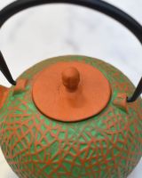 Close up of "Sarda" Green and Orange Cast Iron Japanese Style Teapot lid