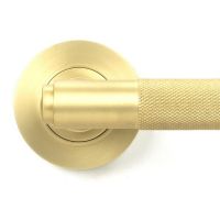 Close-Up of Satin Brass "Royale" Concealed Door Handle on Rose Set